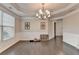 Spacious dining room with hardwood floors, wainscoting, and chandelier at 5525 Nesmith Ct, Cumming, GA 30040