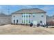 The home's backyard boasts an expansive patio and meticulously maintained lawn, creating a serene outdoor oasis at 5525 Nesmith Ct, Cumming, GA 30040