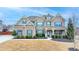 Beautiful two story brick home with well manicured lawn and blue shutters set under a beautiful blue sky at 5525 Nesmith Ct, Cumming, GA 30040