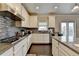 Modern kitchen with white cabinetry, granite countertops, stainless steel appliances, and dark hardwood floors at 5525 Nesmith Ct, Cumming, GA 30040