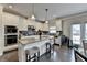 The Kitchen features a granite island, stainless appliances, and dark hardwood floors at 5525 Nesmith Ct, Cumming, GA 30040