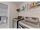 Well-equipped laundry room with modern washer and dryer units at 5525 Nesmith Ct, Cumming, GA 30040