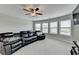 Spacious living room features a ceiling fan and great natural light at 5525 Nesmith Ct, Cumming, GA 30040
