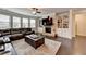 Cozy living room with a stone fireplace, built-in shelving, hardwood floors, and natural light at 5525 Nesmith Ct, Cumming, GA 30040