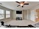 Spacious living room features a ceiling fan and great natural light at 5525 Nesmith Ct, Cumming, GA 30040
