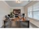 Office featuring a large wooden desk with storage, a large window, and hardwood floors at 5525 Nesmith Ct, Cumming, GA 30040