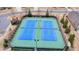 Aerial view of well-maintained tennis courts in the community, ideal for sports enthusiasts and recreational play at 5525 Nesmith Ct, Cumming, GA 30040