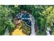 Aerial view of house with manicured lawn, mature trees, and newly paved driveway at 151 John Christopher Dr, Alpharetta, GA 30009