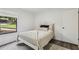 Comfortable bedroom featuring a bed, outside views through the window, and a modern aesthetic at 151 John Christopher Dr, Alpharetta, GA 30009