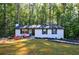 Charming home with freshly painted brick, black shutters, and lovely landscaping creates a welcoming curb appeal at 151 John Christopher Dr, Alpharetta, GA 30009