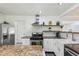 Bright kitchen featuring stainless steel appliances, granite countertops, and sleek white cabinetry at 151 John Christopher Dr, Alpharetta, GA 30009