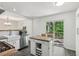 Modern kitchen with an island, stainless steel appliances, and sliding glass doors leading to the deck at 151 John Christopher Dr, Alpharetta, GA 30009