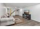 Cozy living room with hardwood floors, a comfortable couch, and direct access to stairs at 151 John Christopher Dr, Alpharetta, GA 30009