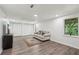 Bright living room features a couch, hardwood flooring, natural light from the window and storage closets at 151 John Christopher Dr, Alpharetta, GA 30009