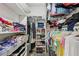 Spacious walk-in closet with built-in shelves and ample storage space for clothes and accessories at 151 John Christopher Dr, Alpharetta, GA 30009