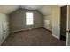 Carpeted attic bedroom featuring a window for natural light and built-in storage at 231 Creek View Pl, Canton, GA 30114