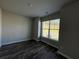Bright bedroom with hardwood floors and a large window providing ample natural light at 231 Creek View Pl, Canton, GA 30114