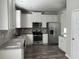 Modern kitchen with stainless steel appliances, granite countertops, and white cabinets at 231 Creek View Pl, Canton, GA 30114