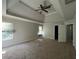 Spacious main bedroom with tray ceiling, ceiling fan, and carpeted floors at 231 Creek View Pl, Canton, GA 30114