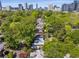 Overhead view of the property showing mature trees, neighborhood and cityscape in the distance at 374 8Th Ne St, Atlanta, GA 30309