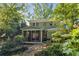 Charming home features a screened porch overlooking a serene backyard pond and seating area at 374 8Th Ne St, Atlanta, GA 30309