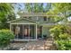 Charming home features a screened porch overlooking a serene backyard pond and seating area at 374 8Th Ne St, Atlanta, GA 30309