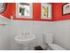 Charming powder room featuring a pedestal sink, toilet, and wainscoting at 374 8Th Ne St, Atlanta, GA 30309