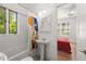 Bright bathroom with a tub, pedestal sink, and a window with a view, connecting to a bedroom at 374 8Th Ne St, Atlanta, GA 30309