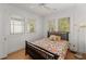 Bedroom featuring hardwood floors, two windows, and an ensuite bathroom at 374 8Th Ne St, Atlanta, GA 30309