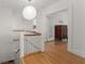Bright hallway with hardwood floors, white railings, and a view into a bedroom at 374 8Th Ne St, Atlanta, GA 30309