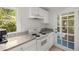 Cozy kitchen featuring white cabinetry, granite countertops, and a door to the outside at 374 8Th Ne St, Atlanta, GA 30309