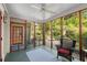Inviting screened porch with a ceiling fan, seating area, and a view of the backyard at 374 8Th Ne St, Atlanta, GA 30309