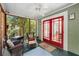 Charming screened porch with red doors and a comfortable seating area at 374 8Th Ne St, Atlanta, GA 30309