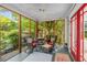 Relaxing screened porch with comfortable seating and open views of the surrounding trees at 374 8Th Ne St, Atlanta, GA 30309