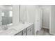 Well-lit bathroom featuring double sinks and modern gray cabinetry at 7757 Sheffield Ter, Fairburn, GA 30213