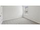 Neutral bedroom with gray carpet, white walls and a view to the street at 7757 Sheffield Ter, Fairburn, GA 30213