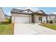 View of the home showcasing the garage, driveway, and attractive architectural details at 7757 Sheffield Ter, Fairburn, GA 30213