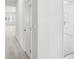 Hallway features durable floors, neutral walls, and doorways leading to carpeted rooms at 7757 Sheffield Ter, Fairburn, GA 30213