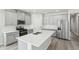 Modern kitchen with grey cabinets, stainless steel appliances, and large island at 7757 Sheffield Ter, Fairburn, GA 30213