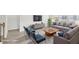 Virtually staged living room with comfortable seating, a stylish rug, and ample natural light at 7757 Sheffield Ter, Fairburn, GA 30213
