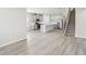 Open-concept living space with stairs, dining, and kitchen areas perfect for modern living at 7757 Sheffield Ter, Fairburn, GA 30213