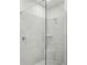 Modern tiled shower stall with glass enclosure and corner seat at 7757 Sheffield Ter, Fairburn, GA 30213