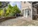 Rear patio with grilling area and stone retaining wall adjacent to house and screened in porch at 3318 Monceau Way, Roswell, GA 30075