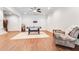 Finished basement with wood floors, neutral walls, and multiple seating areas at 3318 Monceau Way, Roswell, GA 30075