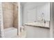 Bright bathroom with a shower-tub combo, white vanity and granite countertop, and toilet at 3318 Monceau Way, Roswell, GA 30075