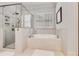 Bright bathroom featuring a soaking tub and frameless glass shower at 3318 Monceau Way, Roswell, GA 30075