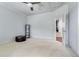 Spacious bedroom with neutral carpet, a leather ottoman, and an open closet at 3318 Monceau Way, Roswell, GA 30075