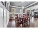 Elegant dining room with hardwood floors, wainscoting, and a view into the foyer at 3318 Monceau Way, Roswell, GA 30075