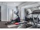Home gym with mirrored wall, cardio machines and free weights at 3318 Monceau Way, Roswell, GA 30075