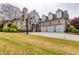 Charming two-story home with a three-car garage, basketball hoop, and lush green lawn at 3318 Monceau Way, Roswell, GA 30075